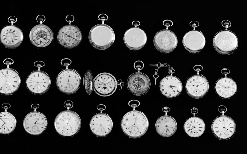 Various vintage pocket watches laid out on a table