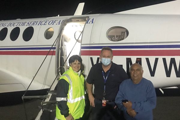 Patient Mervyn Bishop with RFDS Doctors in front plane