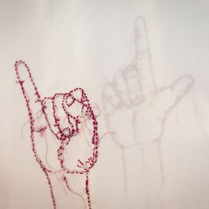 Close up of stitching of a hand signing AUSLAN
