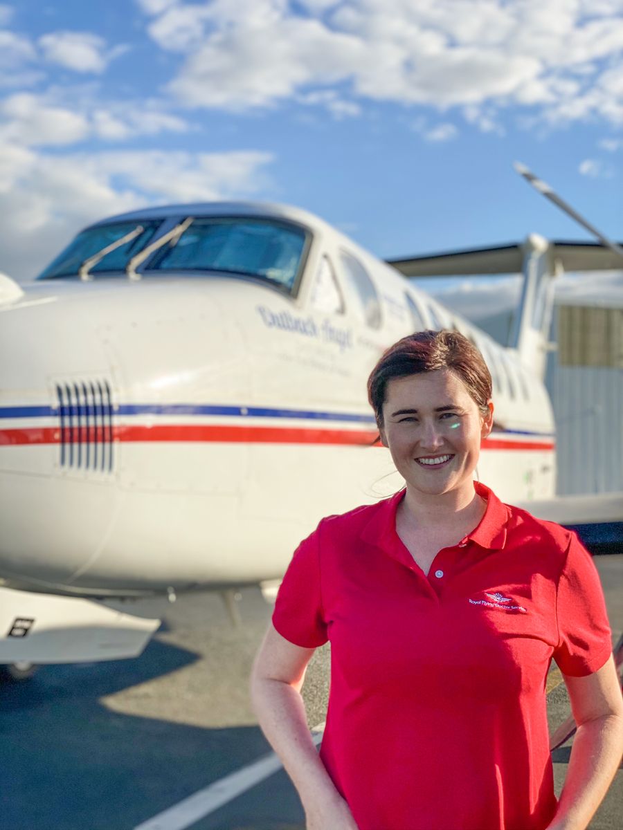 Flight Nurse Megan Wood in front of an RFDS aircraft