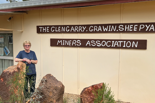 Volunteer Lesley in front of Clinic