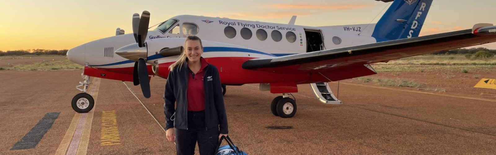 RFDS Flight Nurse Izzy standing in front of RFDS aircraft