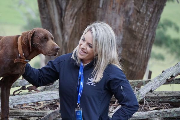 Harriet from RFDS Tasmania with a dog.