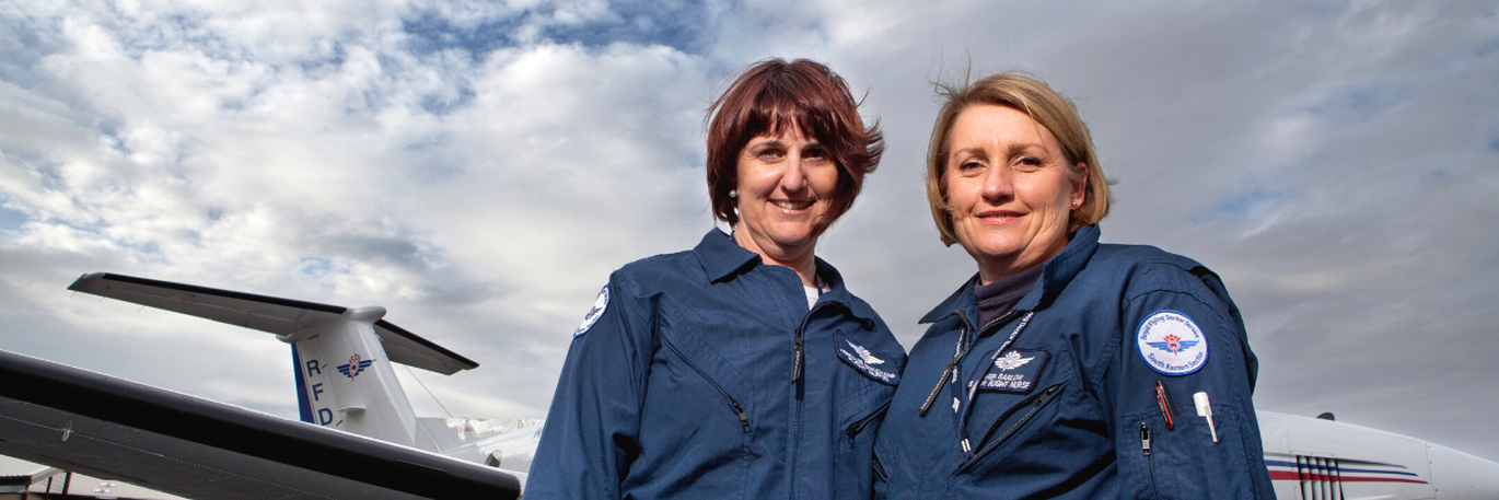 Two Royal Flying Doctor Service flight nurses standing in front of an RFDS Aircraft