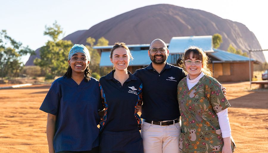 Dr Vai is pictured with some of his specialist dental team in Alice Springs