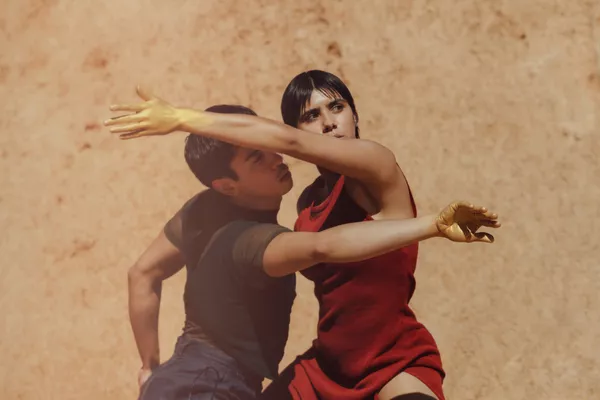 A still shot of two people dancing outside