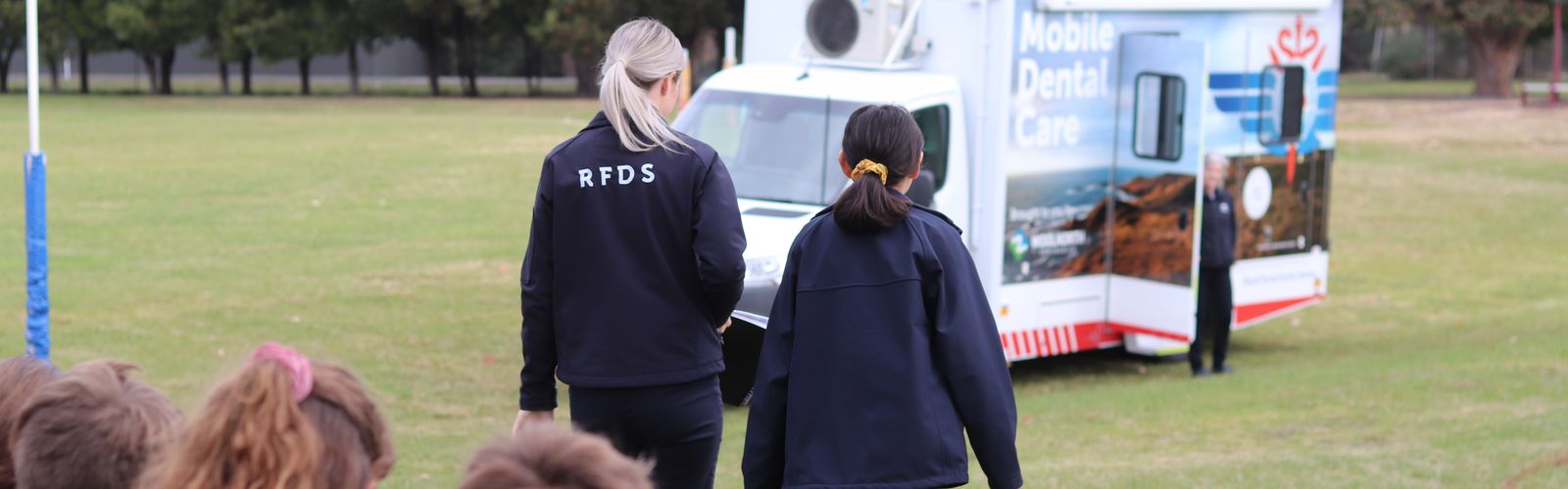 RFDS Tasmania Dental Coordinator with student walking towards mobile dental van.