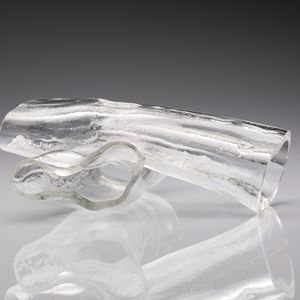 clear blown glass in the shape of 2 hollow logs sat on top of each other at cross angles