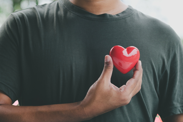 A man holds a heart to his chest