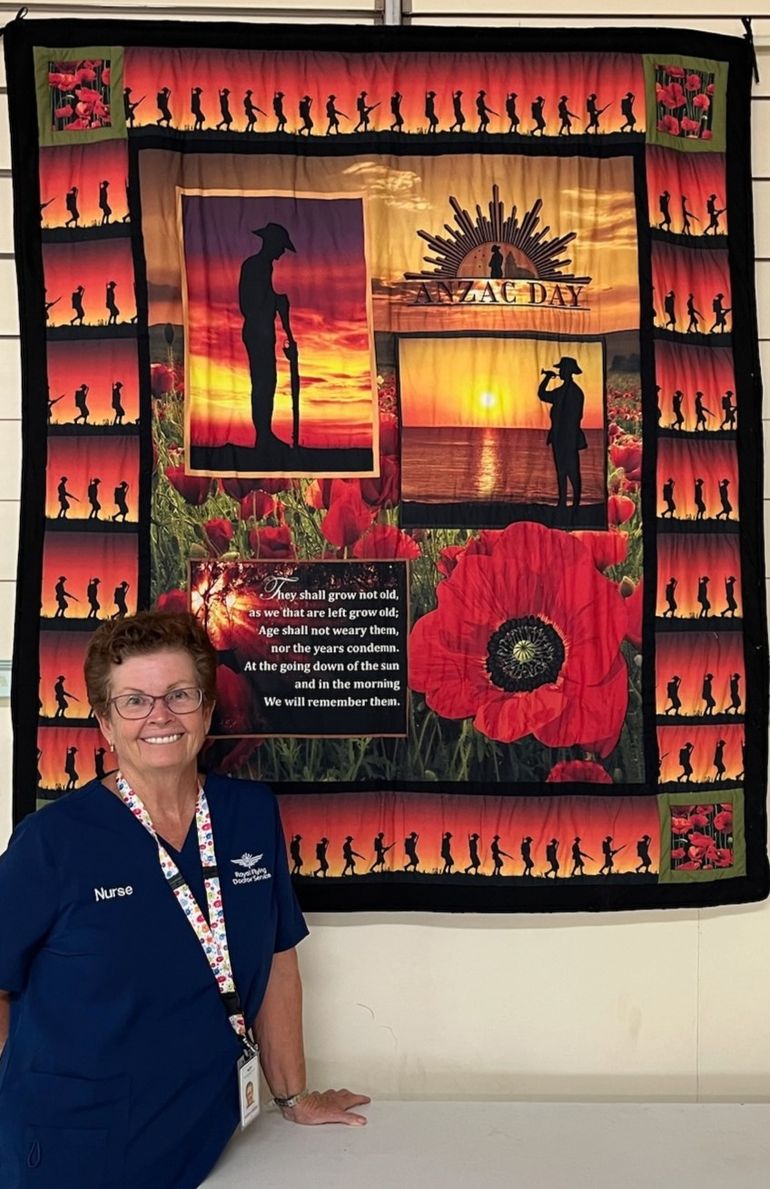 Kathleen Loadsman standing with Anzac Day display.