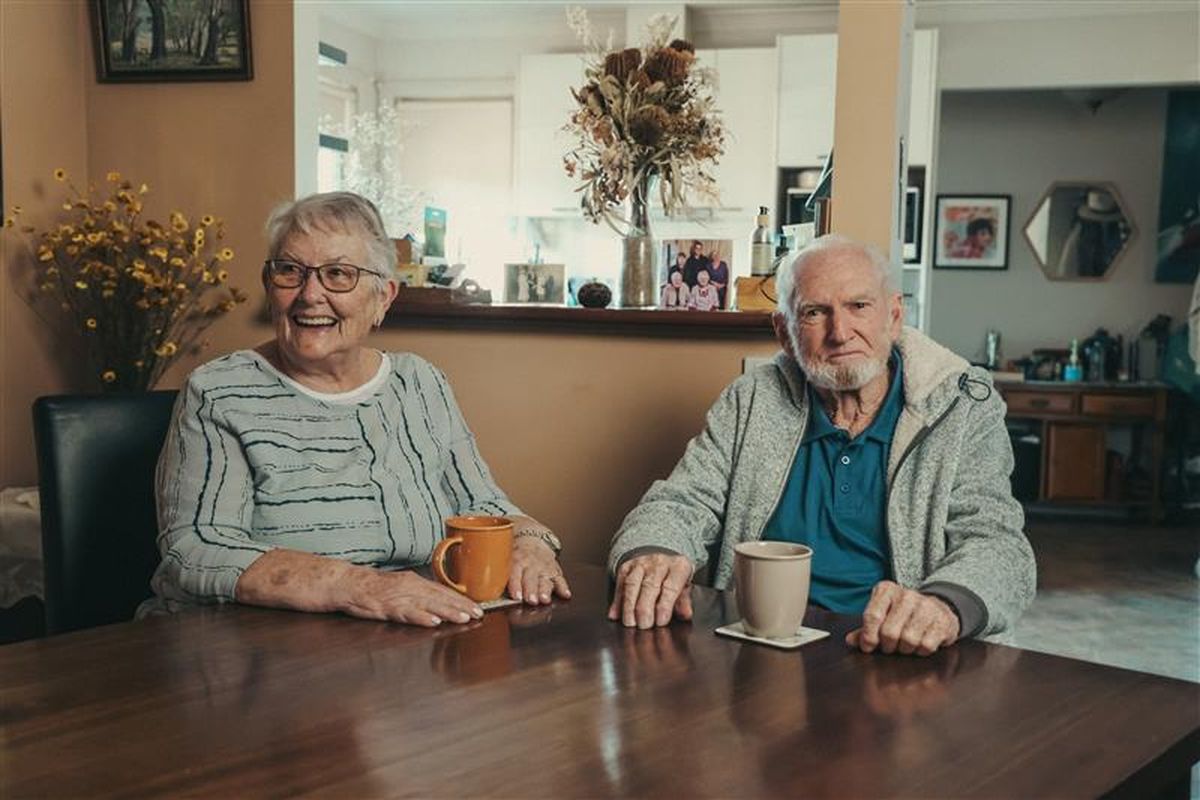 Alan and Lorraine sitting at their kitchen table.