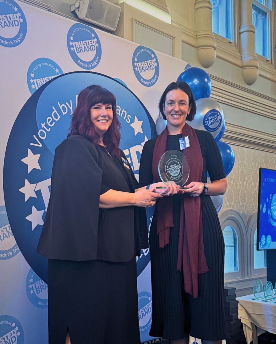 Chief Exec RFDS Emma Buchanan receiving award from Cathy Johnson from Readers Digest