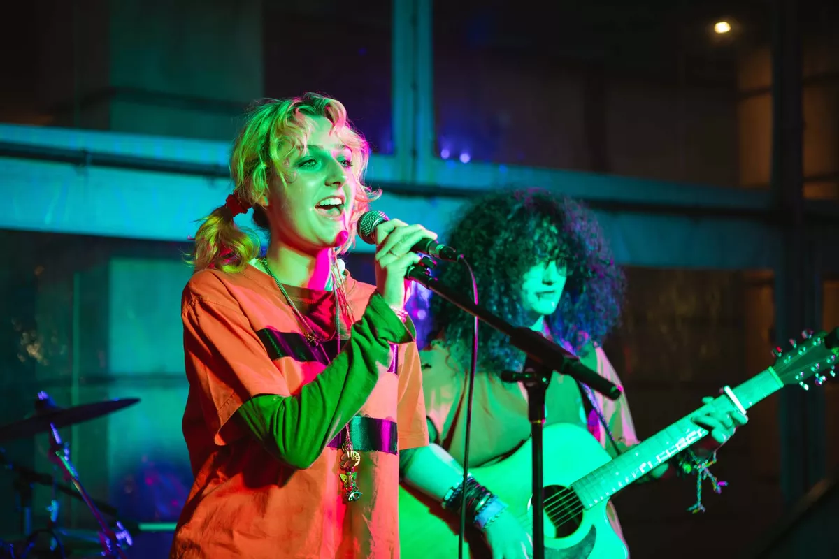 Young person singing into microphone