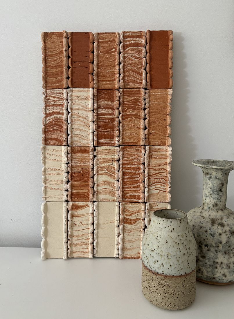 Pressed Wall work in white and achre colours with two small vases in grey at front