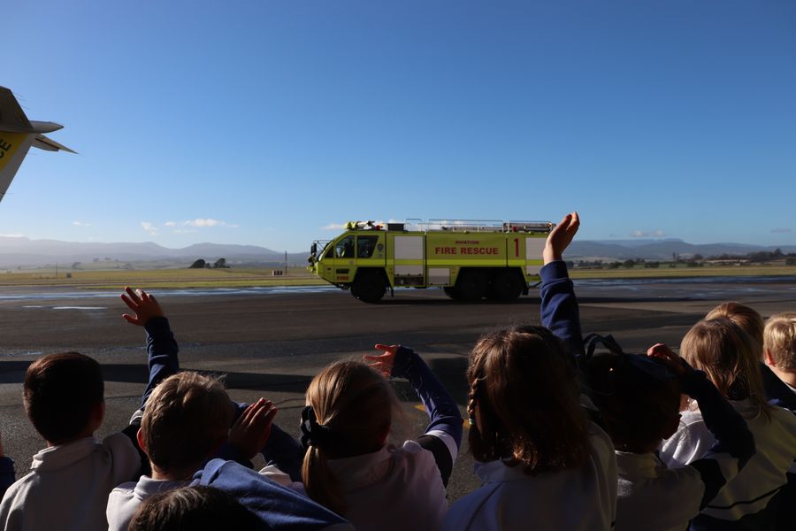 Children at the RFDS Tasmania base waving to the fire truck.