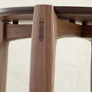 A close up detail of a walnut side table