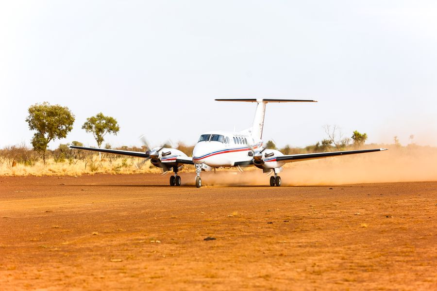 RFDS (Queensland Section) aircraft landing on dirt runway
