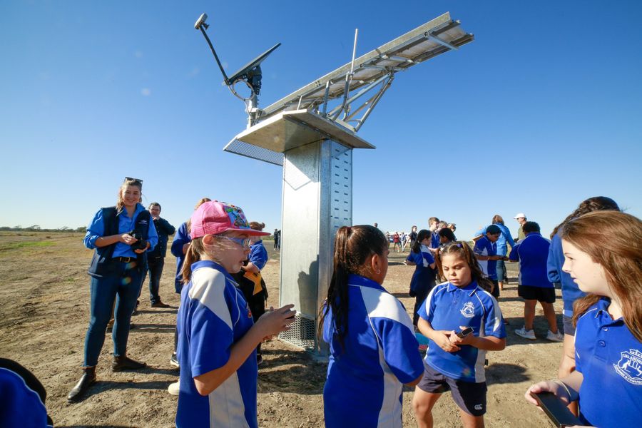 Ground Station Hub surrounded by children from the local school