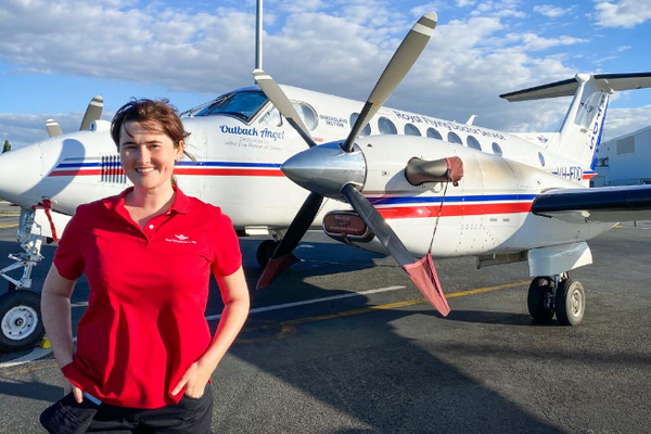 Midwifery scholarship winner Megan Wood in front of an RFDS aircraft