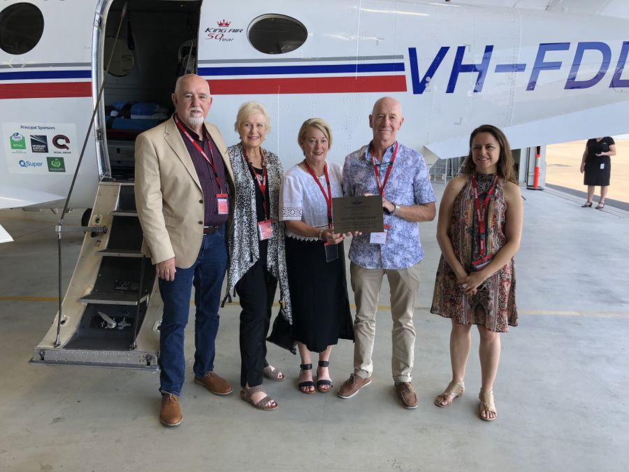 Jennifer's friends holding the plaque