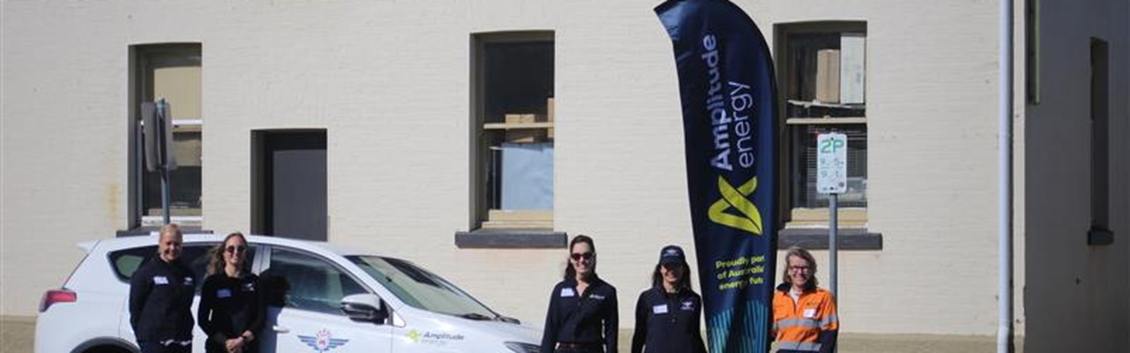 RFDS and Amplitude stand around an RFDS car in Orbost