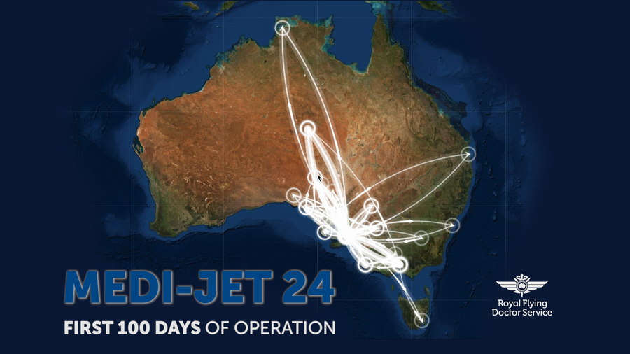 Aeromedical jet stands on tarmac. A woman in high vis vest with RFDS logo pushes a stretcher with patient towards the aircraft. 