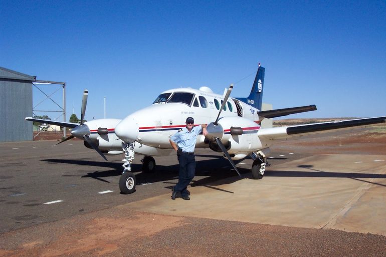 Pilot Simon standing in front of an RFDS aircraft.