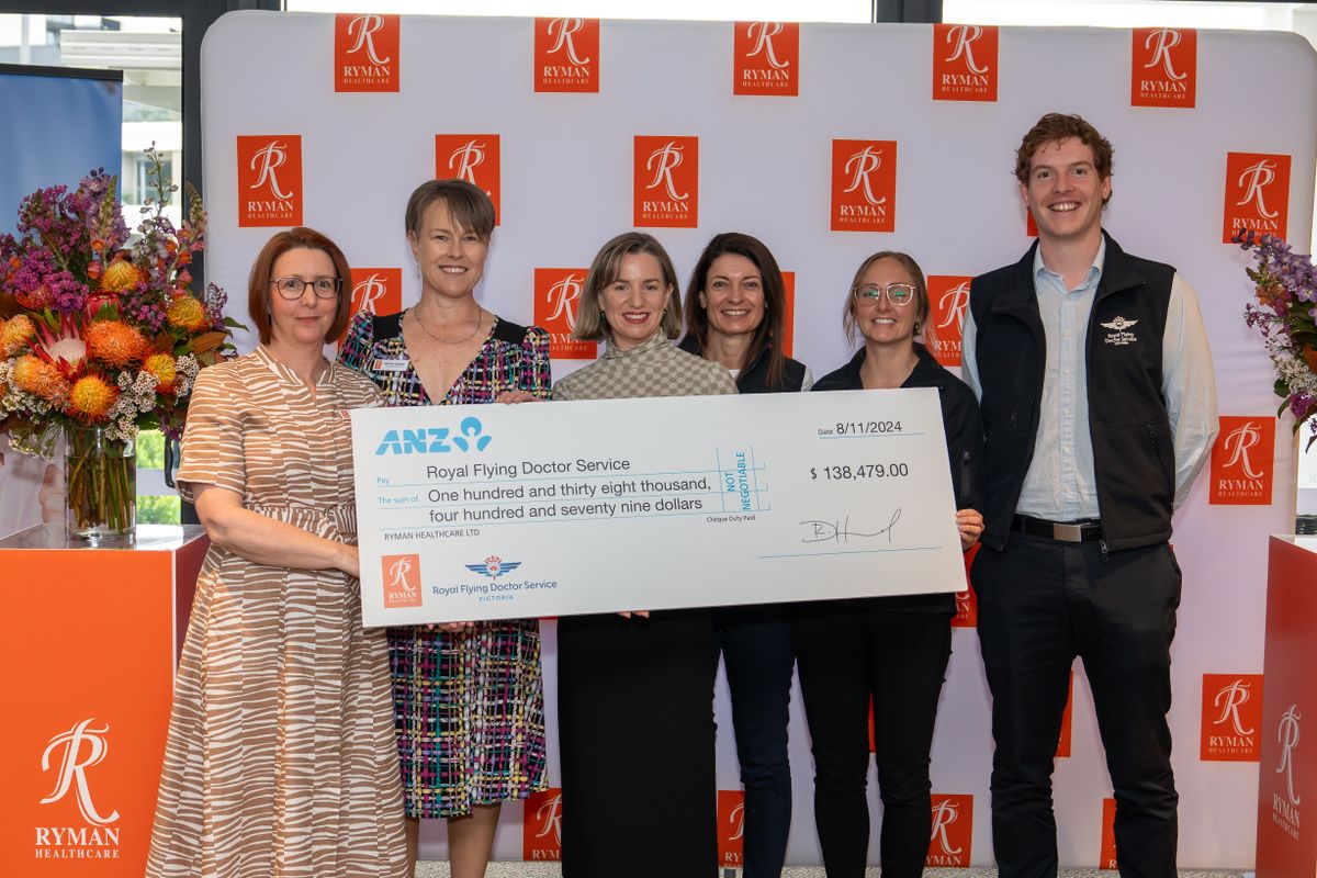 Ryman Healthcare and RFDS Victoria staff with a large cheque at a corporate partner event