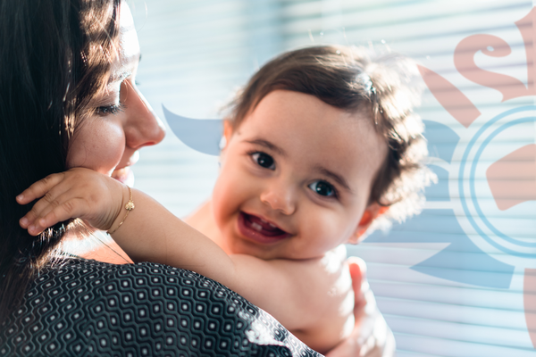  A woman holds her smiling baby