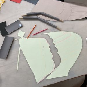 work table with paper templates, pencils and scissors