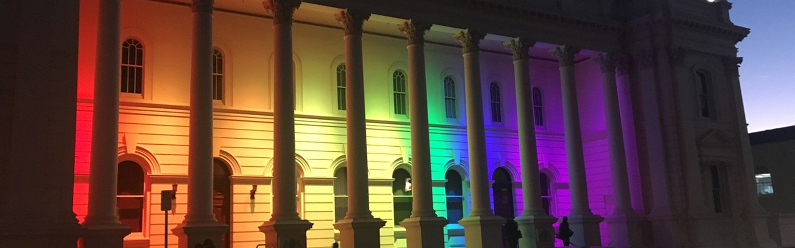 Launceston town hall lit up in multicolour
