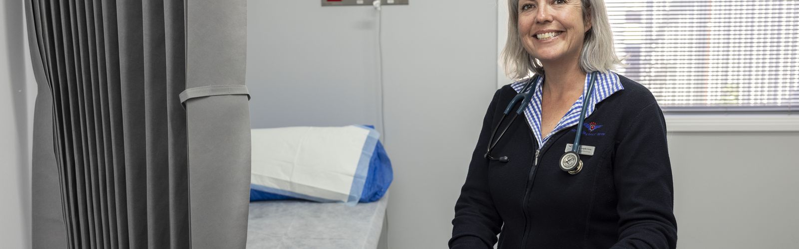 GP Angela Gray smiles in consultation room 