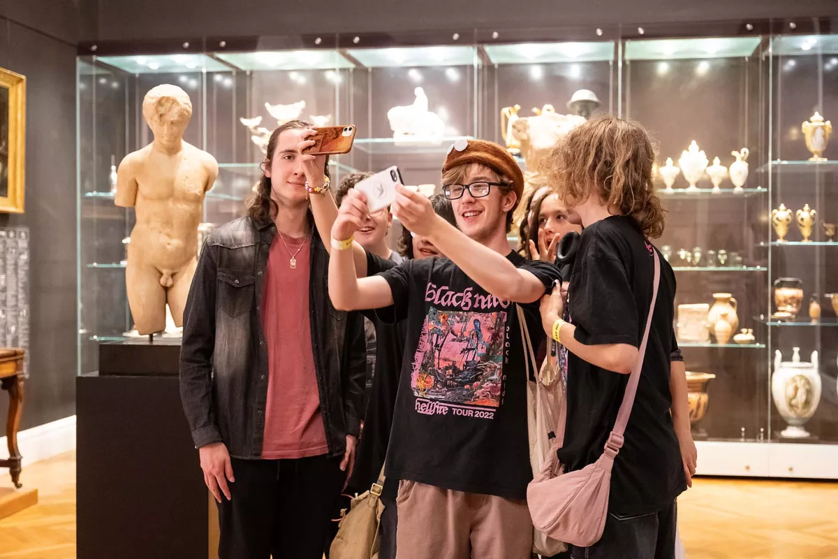 Young people taking selfie with phone.
