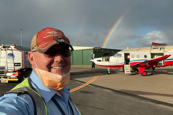 Pilot Simon Phelps taking a selfie infront of an aircraft.