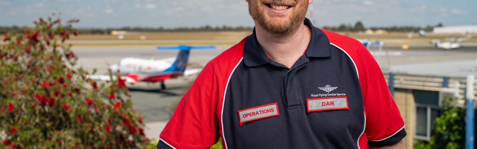 Dan smiling with a PC-12 in the background.