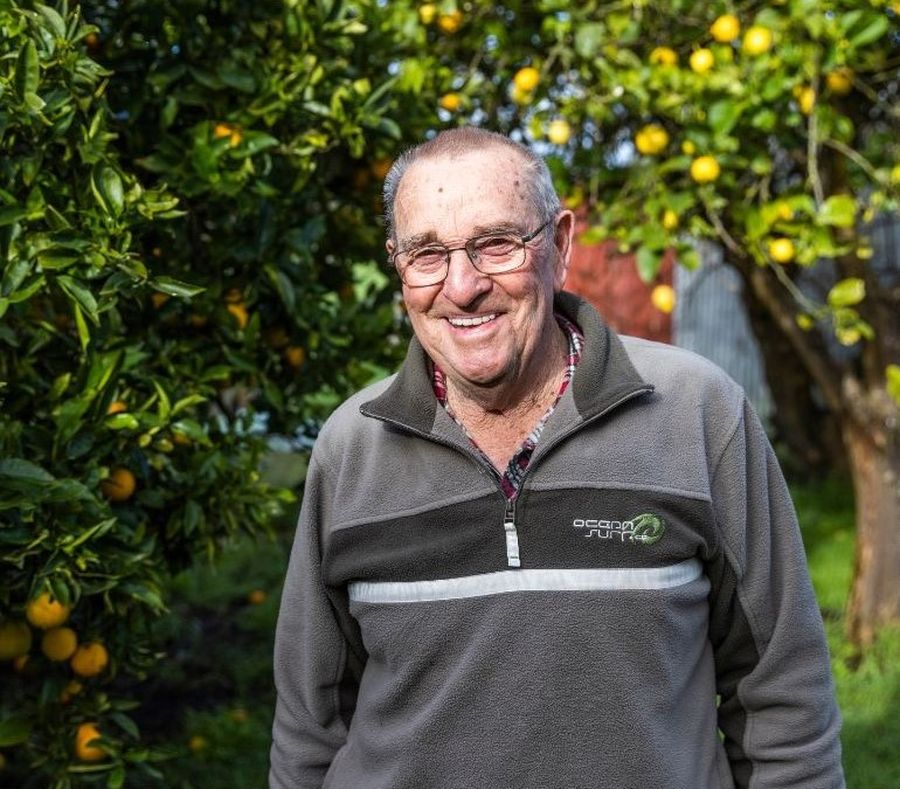 George smiling in front of lemon trees