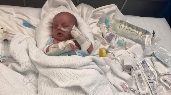 Baby Jack is in a hospital bed with medical equipment