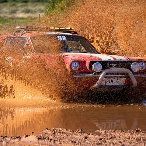 Car driving through muddy waters