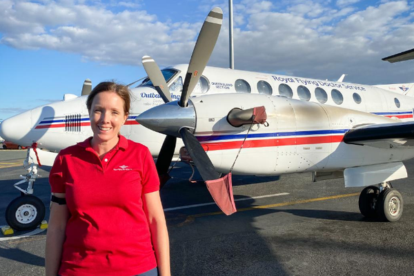 Elizabeth Ferrier standing in front of an RFDS plane