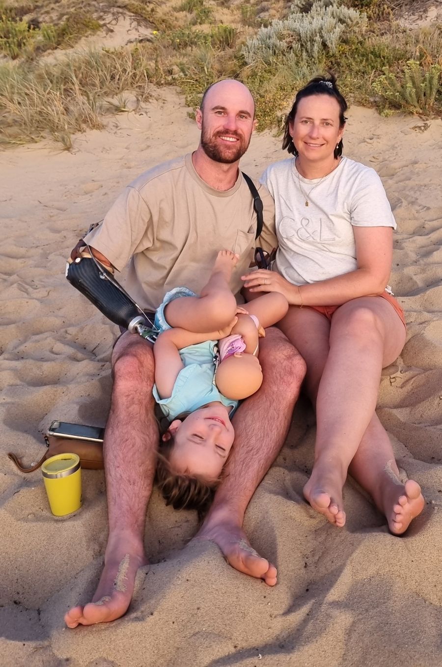 Sean pictured with his wife Claire and daughter Mila on a beach