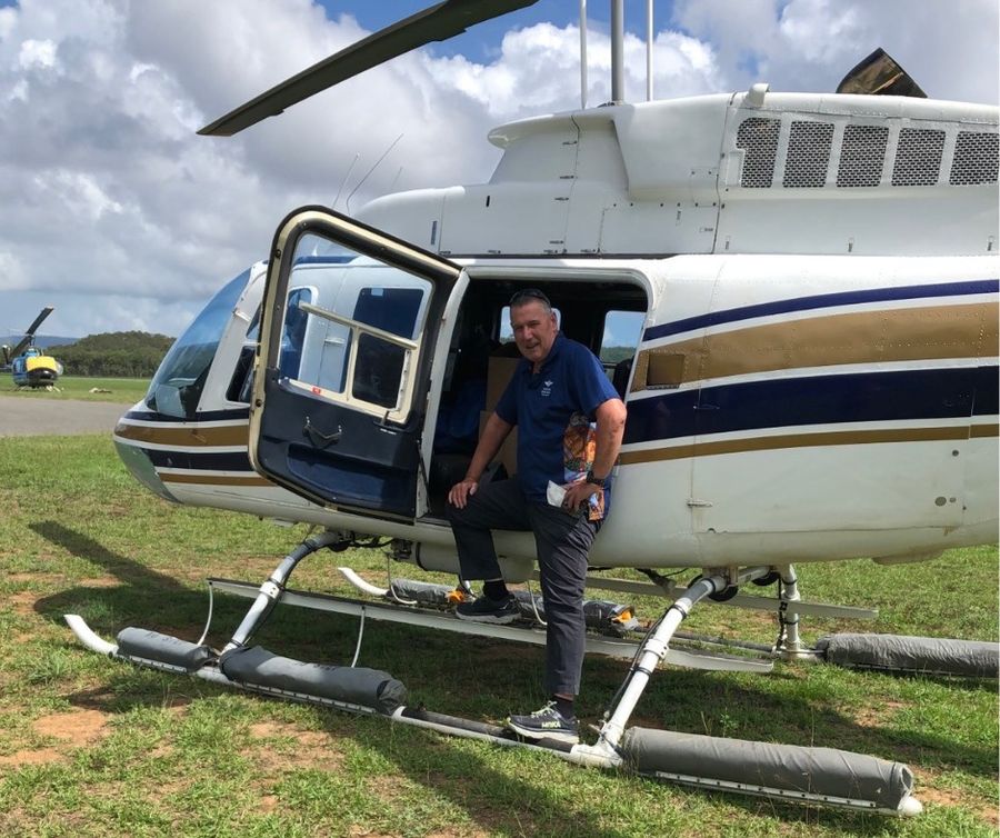 Stephen travelling in helicopter to flooded areas.