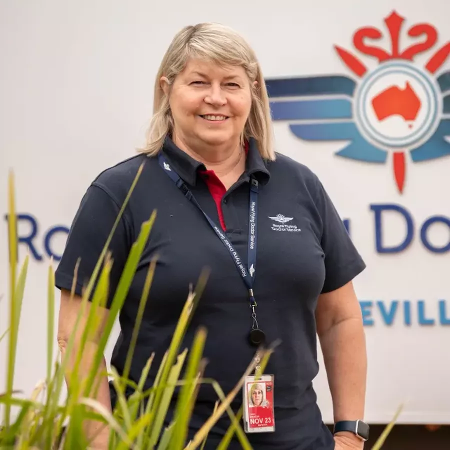 Liane Spencer has blonde hair and is wearing a navy RFDS uniform smiling at the camera.