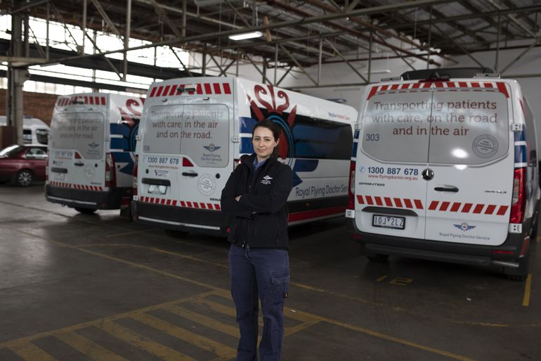 RFDS Victoria staff stands in front of patient transfer vehicles