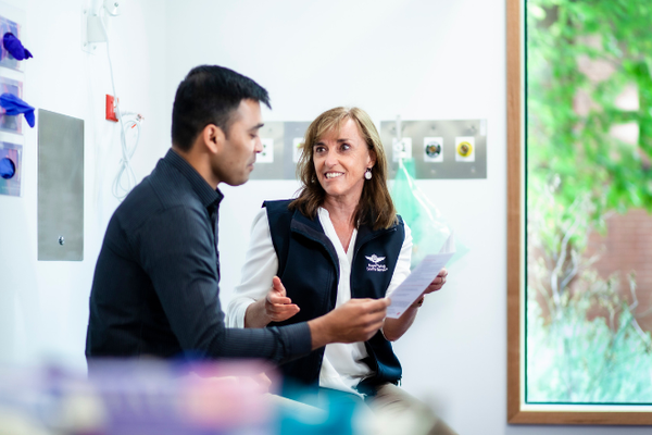 RFDS staff member and patient smile as they talk.