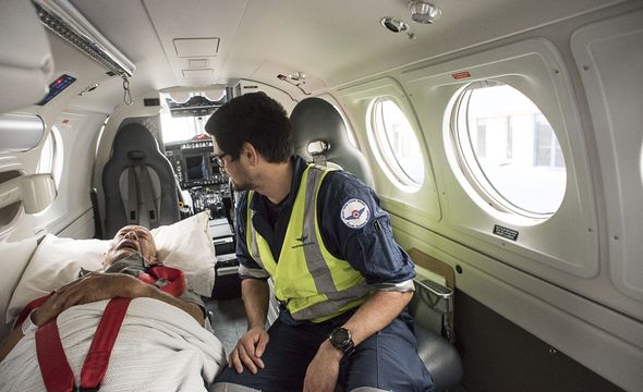 patient in stretcher in aircraft