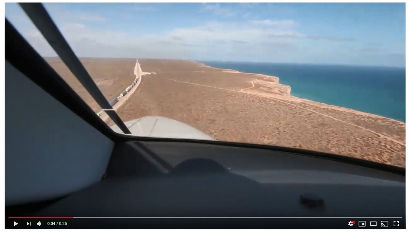 A video shot through the window of a cockpit. The plane is descending onto a road airstrip very close to the coast of Western Australia. 