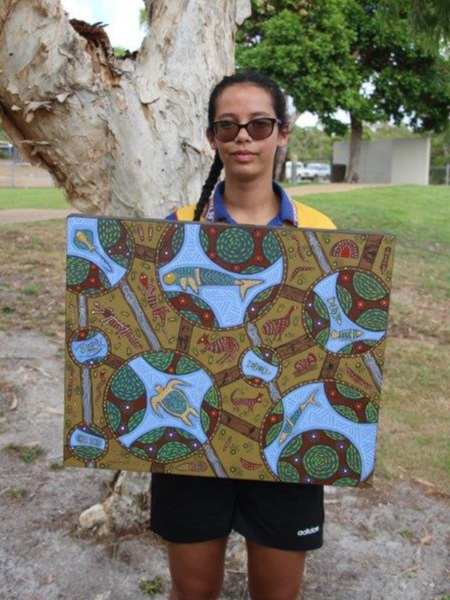 Wudarabin Snider holding her winning entry in an Indigenous Creative Art Competition staged by the Royal Flying Doctor Service (Queensland Section).