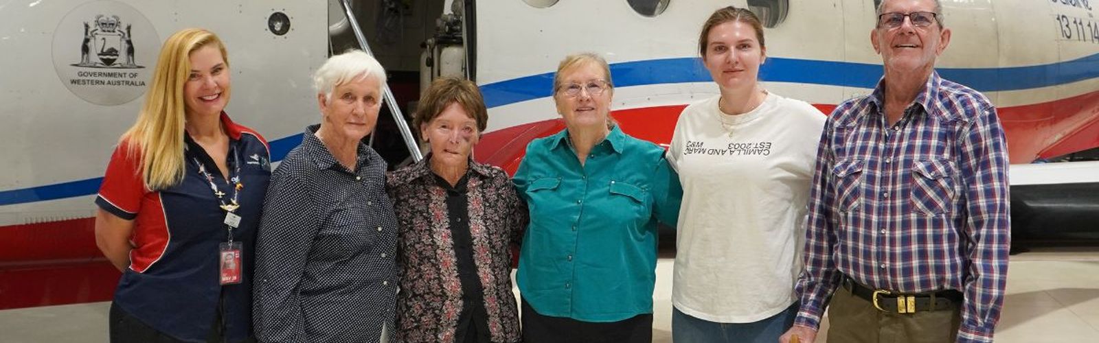 Ancestors smiling in front of a PC-12.