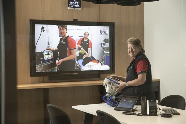 students with flight nurse in aircraft
