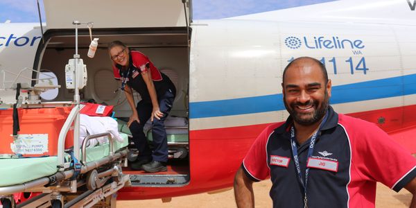 Dr Jig smiling in front of a PC-12.